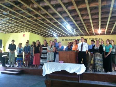 Team singing to Congregation